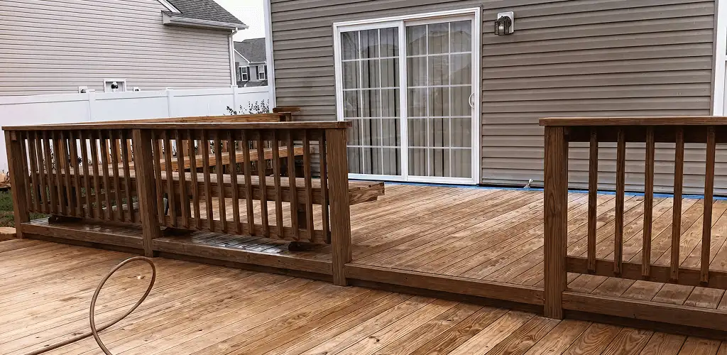Deck sealing service protecting a backyard wood deck and railings in Aurora, CO