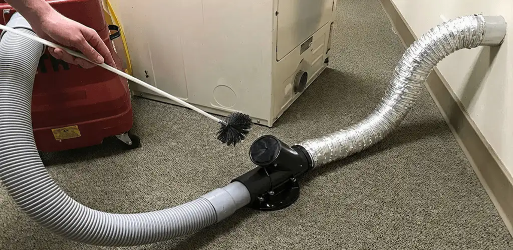 Dryer vent cleaning service removing lint from a dryer duct connection in Aurora, CO