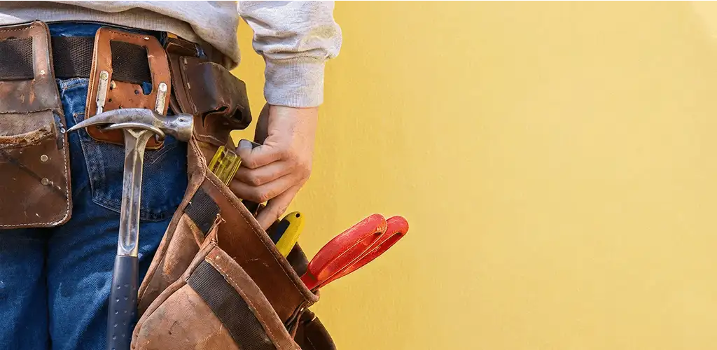 Handyman with tool belt ready for home repairs and maintenance in Aurora, CO