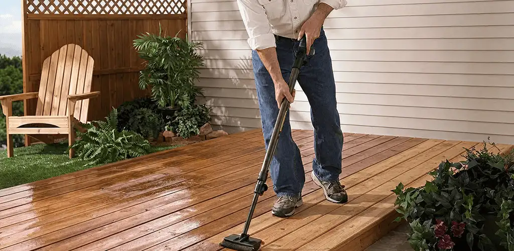 Deck staining service applying stain to a backyard wood deck in Aurora, CO